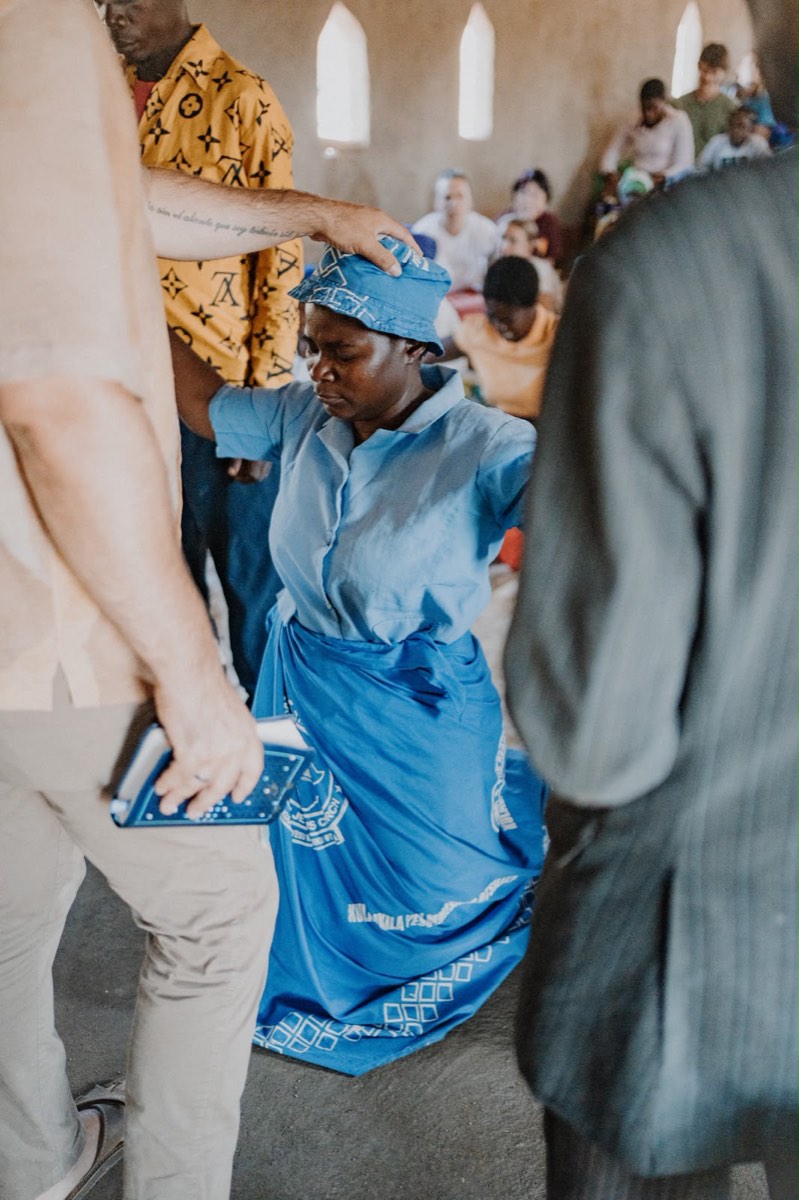 Praying over a woman in church
